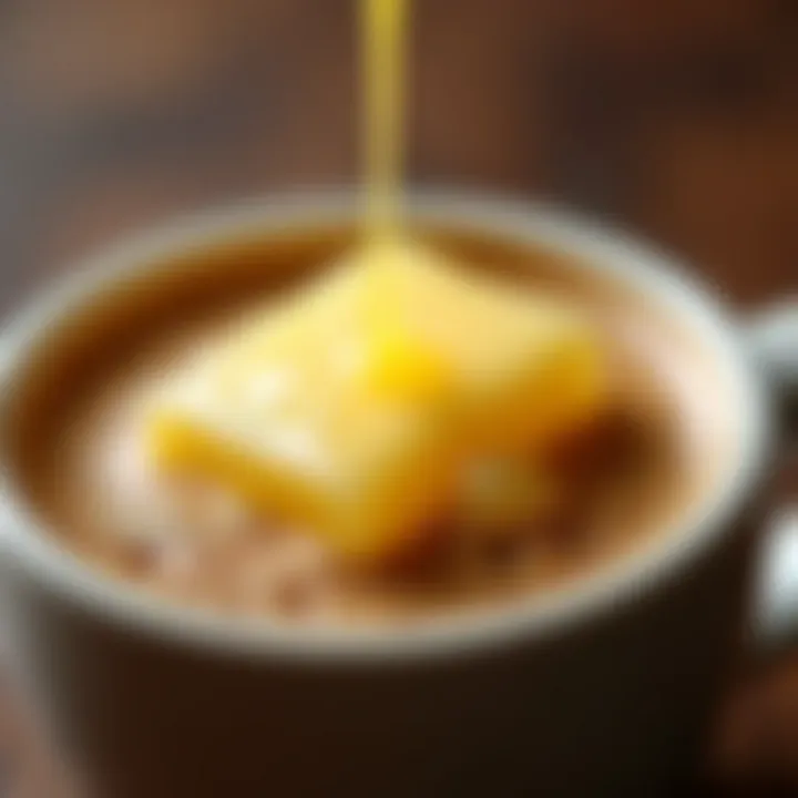 A close-up of frothy butter blended into hot coffee