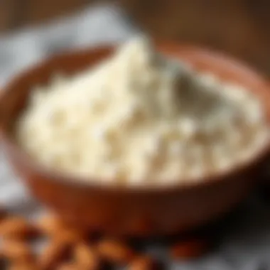 Close-up of almond flour texture in a bowl with almonds scattered around