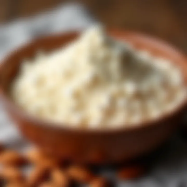 Close-up of almond flour texture in a bowl with almonds scattered around